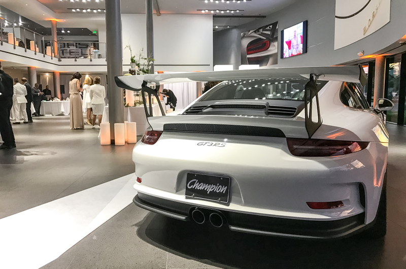 Illustration for article titled This Couple Topped Your Wildest Dreams By Getting Married In A Porsche Showroom